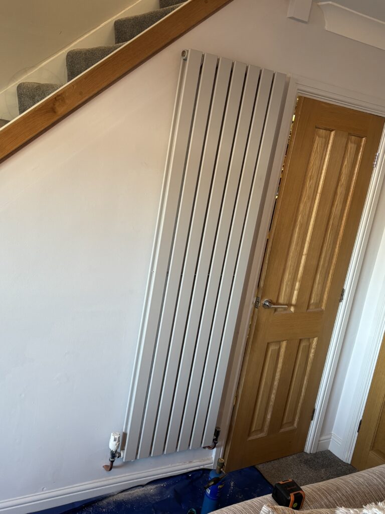 Vertical radiator and pipe connections at the Tingley home